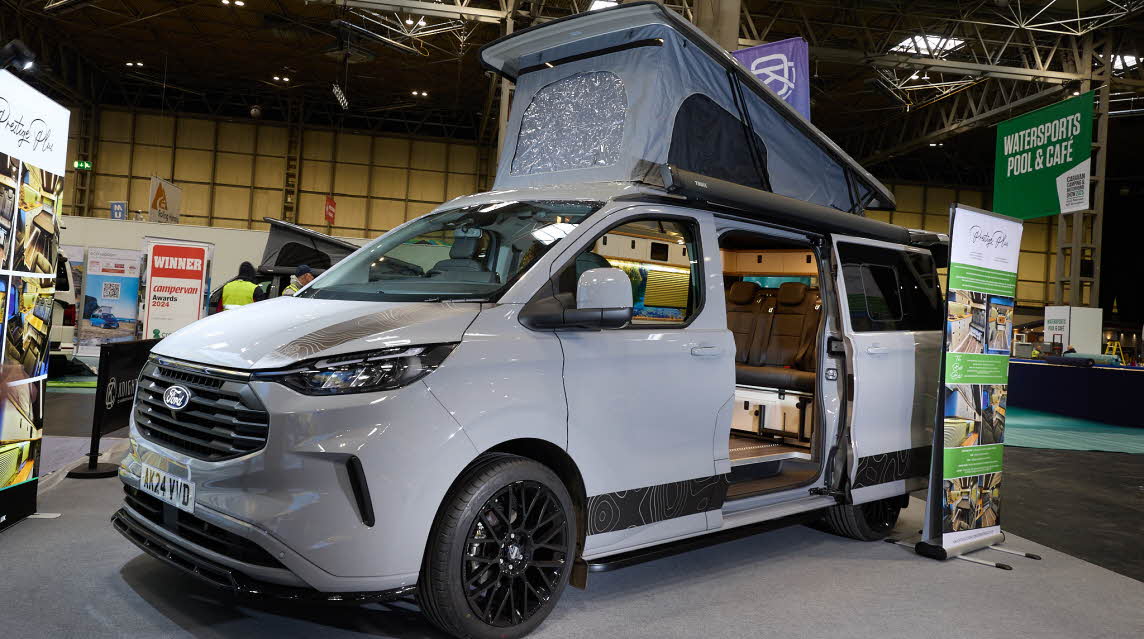 The Knights Custom Conversion Prestige Tourer Plus is grey.  The sliding door is open and its rising roof is fully extended.