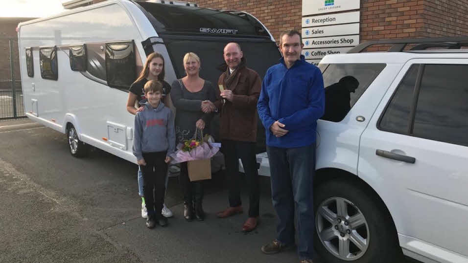 a family picking up their new caravan