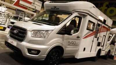 The Roller Team Kronos Compact 590 has a silver cab and a white coachbuilt body, it has grey and red stripes.  The figures 590 are on the passengers door.