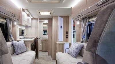 Coachbuilt interior, cream upholstery, wooden furniture