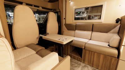 The Roller Team Kronos Compact 590 has coffee and cream upholstery.  There are five seats around the wooden extendable table.  There is a storage area under the middle seat.