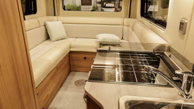 The Auto-Trail V-Line 610 Sport has cream upholstery, the kitchen sink and hob is in the foreground