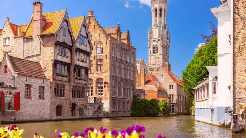 Scenic sunny medieval fairytale town and tower Belfort from the quay Rosary in Bruges, Belgium