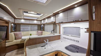 A Class interior, skylights, wooden furniture, cream upholstery, black fridge