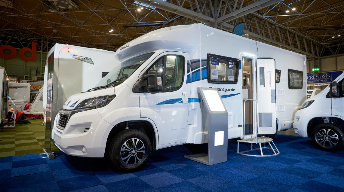Exterior, coachbuilt motorhome, white with blue/grey accent stripes