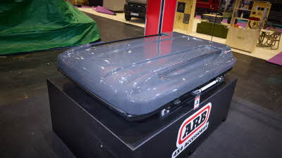 The ARB 4x4 Accessories Altitude is closed and ready for travel. The hard top of the box is pale grey.