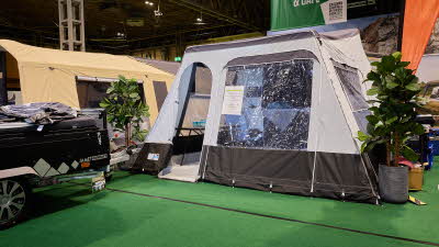 The Jamet Compact Eco has a grey and brown canvas. The door is open revealing the interior. The folded unit, in black, is to the left.