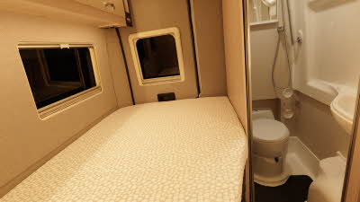 The Auto-Sleeper Active KB635 has a fixed rear French bed next to the washroom.