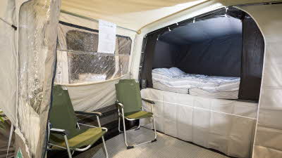 Campmaster 1000LX interior, separate bedroom compartment, sitting area, two chairs