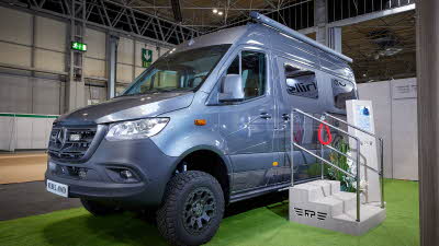 RP Motorhomes Rebel AWD U has a metallic grey exterior, there are three steps for easy access.  The wheels are black alloys.  