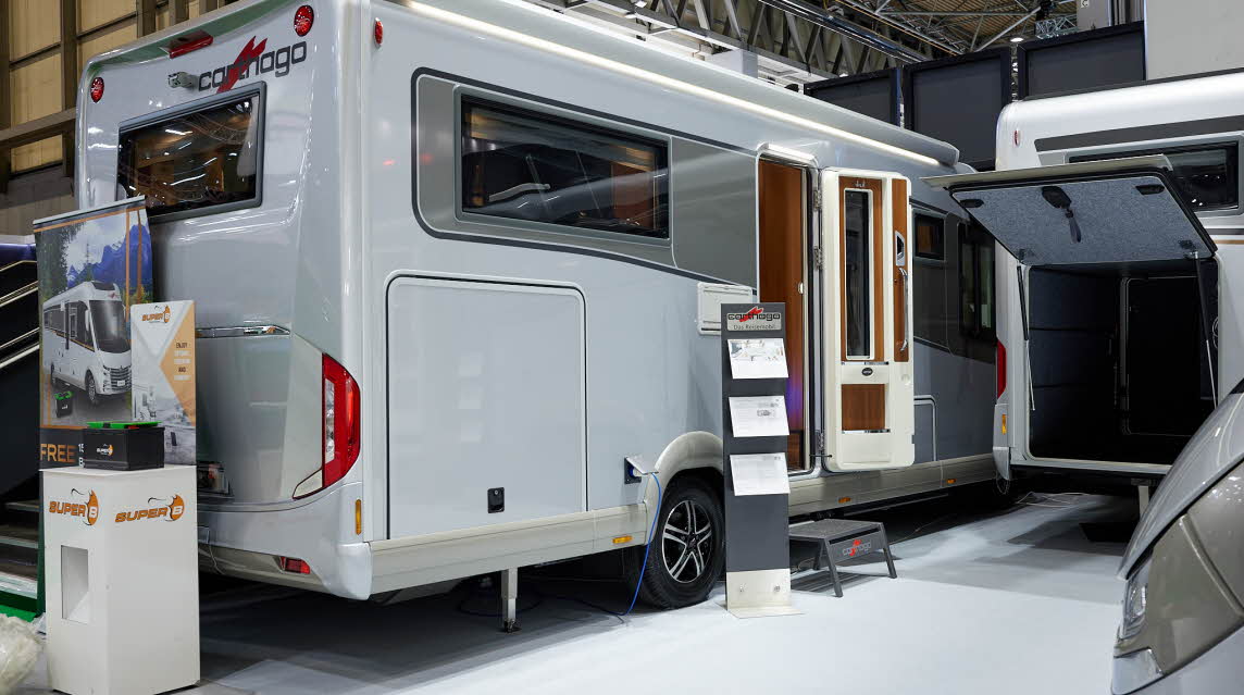 Carthago liner-for-two I 53 has a silver exterior, its habitation door is open showing into the interior, with a step to gain easy access.  