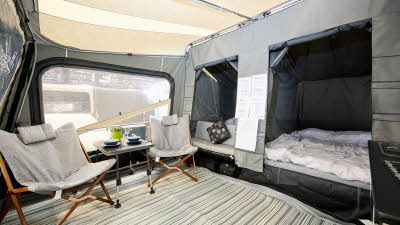 Camp-let Passion interior, two bedrooms, stripy groundsheet, chairs and a table