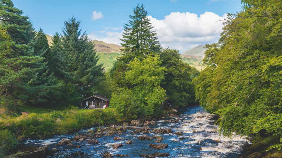 Falls of Dochart in Killin surrounded by pine trees in spring