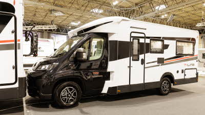The Roller Team T-Line 700 has a black cab and white coachbuilt body which is decorated with black and red decals.  