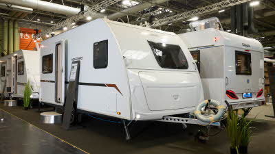 Weinsberg CaraCito 450 FU's exterior is white with an offside front window.  The door is open and there is a step to enable easy access to the interior.