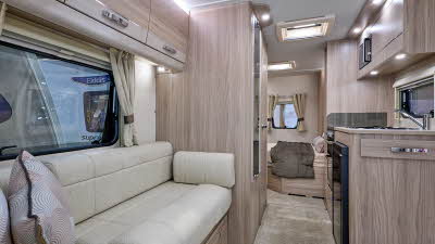 Elddis Avante 454's interior has pale wood furniture and its upholstery is cream.  The bedroom is to the rear and it has a large skylight.