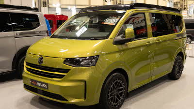 The Hillside Leisure Birchover Classic is in Warm Green, its rising roof and doors are closed.