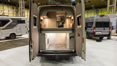 The Mega Mobil Mega Classic 600 S Hubbett's rear doors are open revealing the rear fixed bed.  Under the bed is a large storage area with further cupboards.