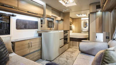 Interior of the Bailey Alicanto Grande Alvor with grey sofas, cosy cushions and wood accents, large windows and three skylights will let natural light flood in.  Perfect for relaxation and designed for comfort.