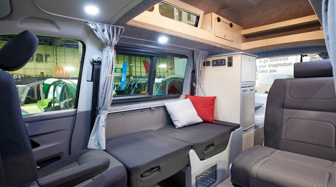 Campervan interior, grey upholstery, light grey curtains