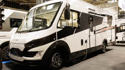 The Roller Team Pegaso 740 has a black and white exterior with a red stripe.
