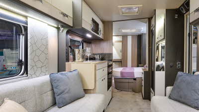 Swift Conqueror 580 interior, cream upholstery, cream lockers, lounge, kitchen, fixed bed, skylights