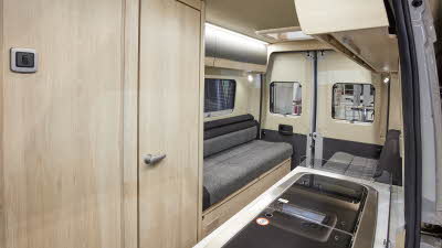 Van conversion interior, wooden furniture, grey upholstery