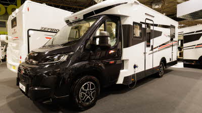 The Roller Team T-Line 750 has a black cab and white coachbuilt body.  It has black/red decals.  