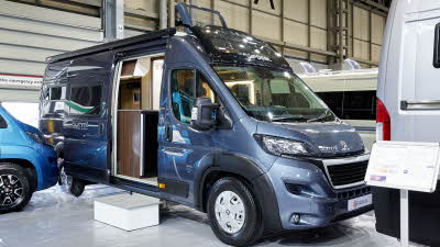 Globecar Summit Prime 640, the vehicle has a grey exterior and its sliding door is open showing into the interior, with a step to gain easy access.  