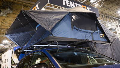 TentBox Lite XL has blue and black canvas. It has an extension. It is shown on a blue Audi.