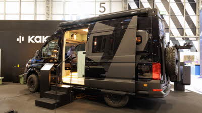 The Kaktus Adventure Vans Dune is black, its sliding door is open and there are three steps to gain easy access.