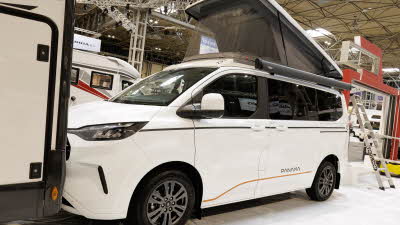 The Panama P\12 is white with black and orange decals.  Its rising roof is open.