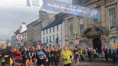 Lots of people running on the road in Kendal