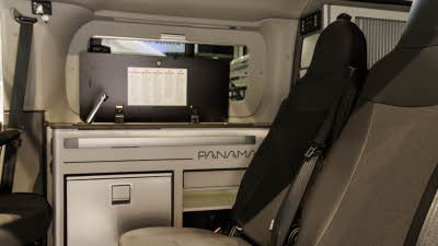 The Panama P\12 has two tone upholstery (grey and beige), it has silver tambour doors on its cabinets with a silver fridge.