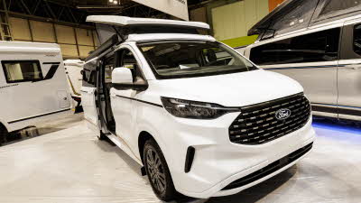 The Panama P\57 is white, its rising roof and sliding door are open.