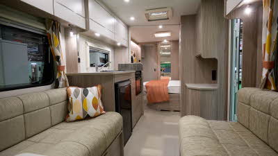 Xplore 554 interior, beige upholstery, wooden furniture, lounge, kitchen, fixed bed, washroom, three skylights