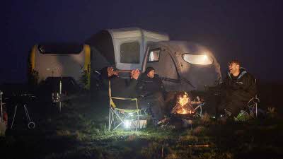 BBC Top Gear presenters around a campfire