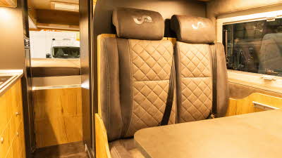 The Mega Mobil Mega Re-Aktiv 680S 4X4 has two tone brown leather upholstery.  The interior décor is primarily wood, there is a fixed rear bed with two skylights above it.