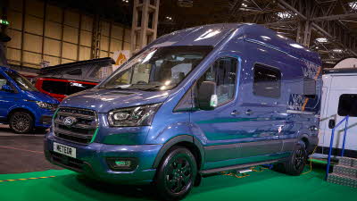 WildAx Motorhomes Meteor is blue with black trim.  There are white and orange decals.  