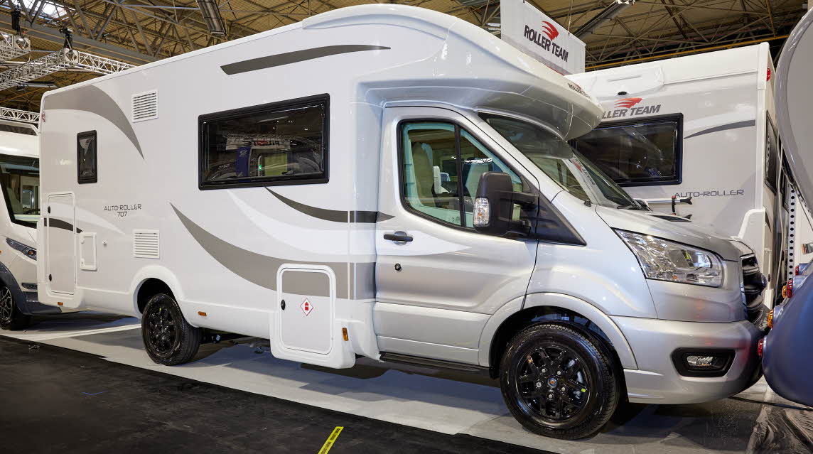 Roller Team Auto-Roller 707 has a silver cab with a white exterior and grey/silver decals.  The wheels are black alloys.  