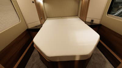 The Auto-Trail Grande Frontier GF-80 has a fixed rear bed with brown carpet and two large windows.