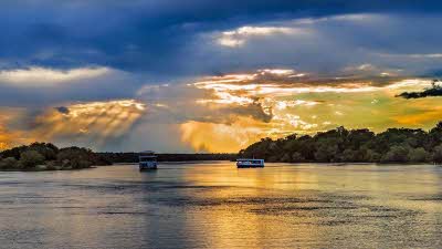 boats at sunset on the Zambezi river near Livingstone
