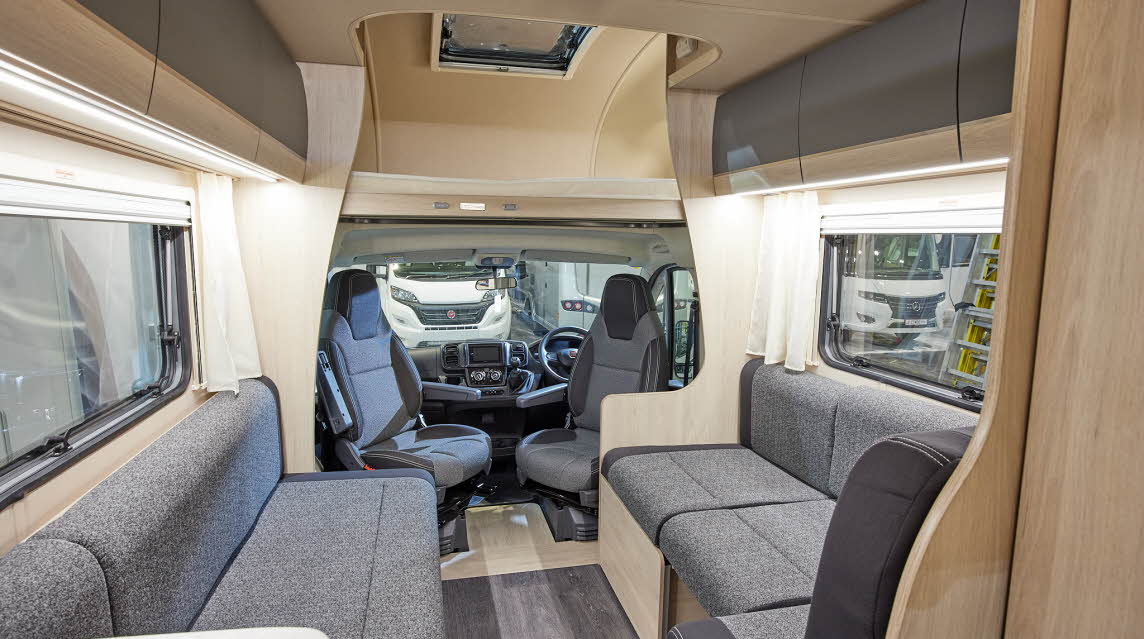 Coachbuilt interior, grey upholstery, wooden furniture