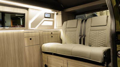 The Hillside Leisure Birchover Classic is in Warm Green, its rising roof and doors are closed.The Hillside Leisure Birchover Classic has cream upholstery and its cabinets are made from light wood.