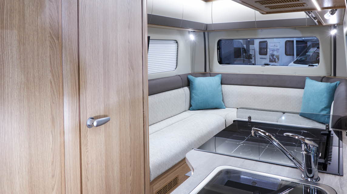 Interior, L shaped sofa, turquoise cushions, kitchen sink