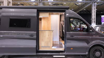 The Mega Mobil Mega Lounge 680 S Twin is grey.  Its sliding door is open.