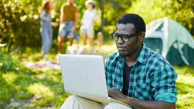 Man at campsite with his laptop