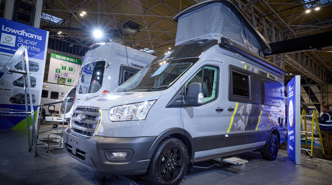 The Swift Trekker X is grey with black trim with yellow, grey and black decals.  The habitation step is extended.  The rising roof is fully extended.