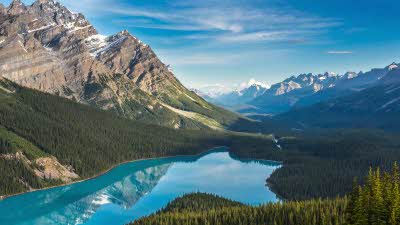 Blue waters of Peyto Lake reflecting the Rocky Mountains above
