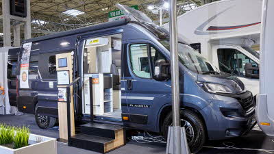 Adria Twin Supreme 640 SLB exterior, van conversion is blue the sliding door is open showing into the interior, with a double step to gain easy access and the roof light is open.  